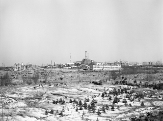 Nuclear power plant with concrete sarcophagus over the nuclear reactor where the accident took place.